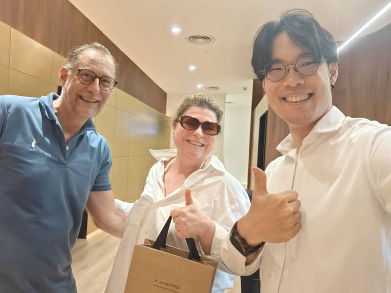 Happy customers outside Optical X Vision Care Center Riverside Plaza Bangkok